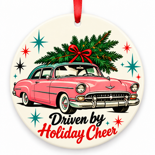 Driven by Holiday Cheer Christmas Ornament – Retro 1950s Pink Car with red hanging ribbon