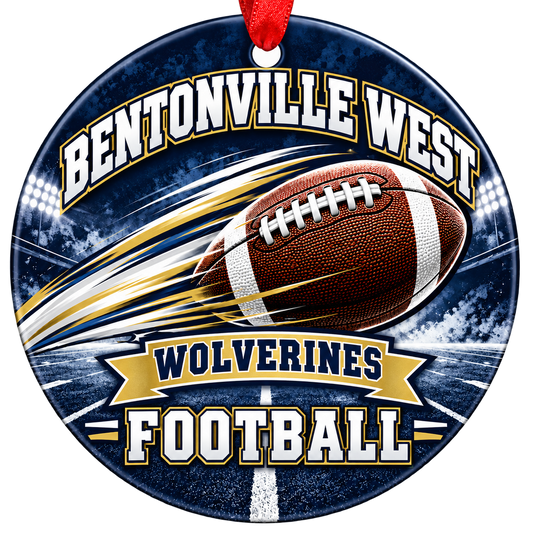 Bentonville West Wolverines Football ornament, football with motion streaks and stadium lights, navy and gold, red hanging ribbon.