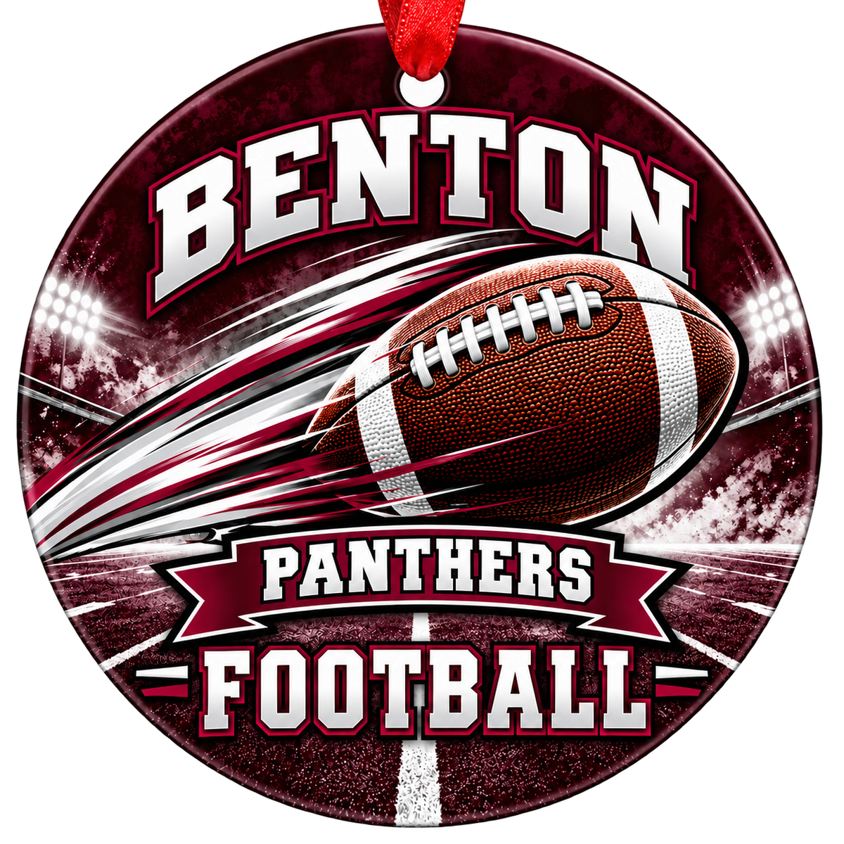 Benton Panthers Football Christmas ornament with football with motion streaks and stadium lights in maroon and gray, red hanging ribbon.