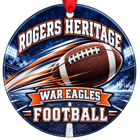 Rogers Heritage War Eagles Football Christmas ornament with football with motion streaks and stadium lights in navy blue and orange, red hanging ribbon.