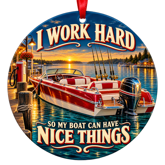 A polished red-and-white motorboat sits beside a marina dock in golden evening light. Round ornament with red hanging ribbon.